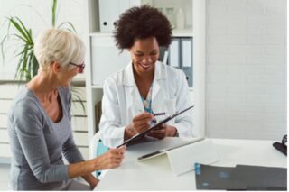 Photo of doctor with elderly volunteer. Age diversity in clinical research.